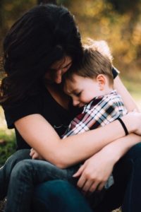 mother spending quality time with toddler by holding him