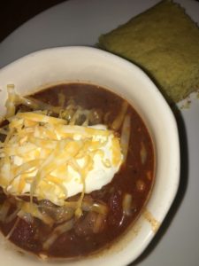 Simple Classic Chili in a bowl with cornbread on the side
