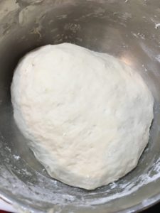 Pizza dough in a bowl rising