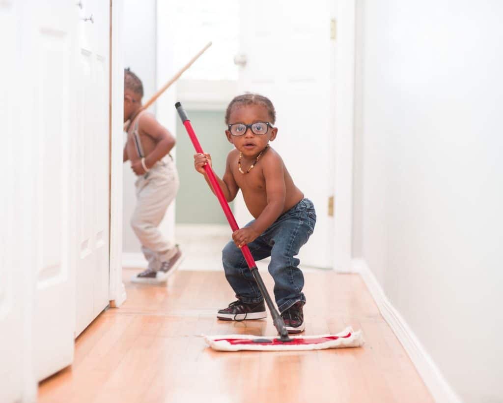Child mopping the floor helping mom enjoy daily chores
