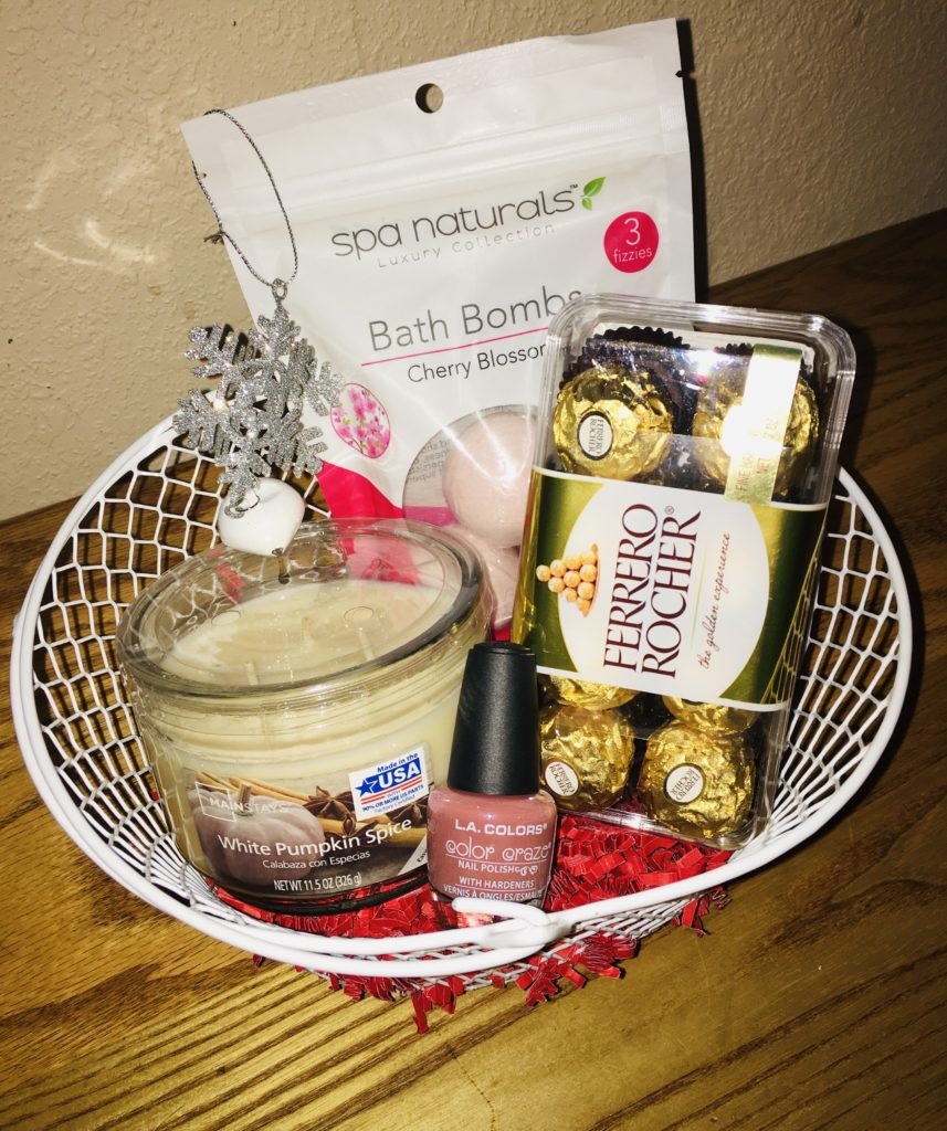 For her women's gift basket under 20 wire basket including bath bombs, 3 wick candle, Ferroro Rocher chocolates, nail polish and an ornament