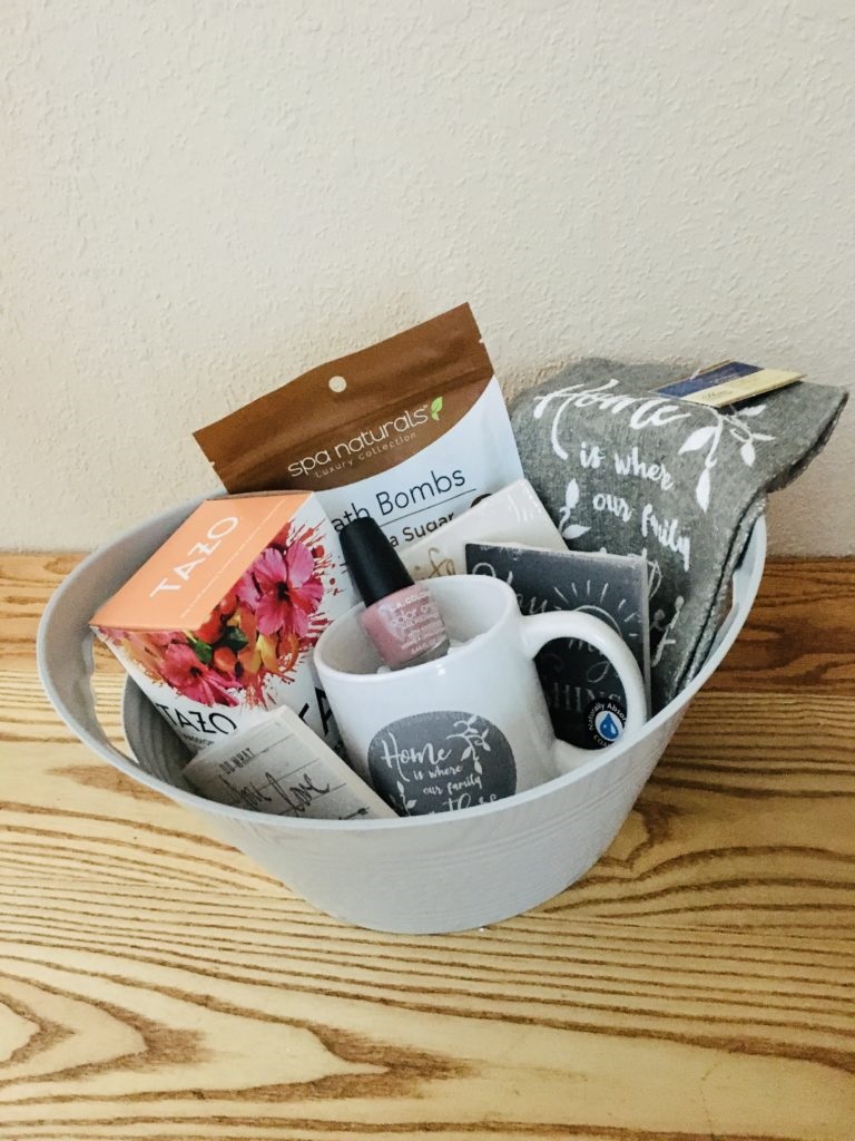 Tea themed gift basket with Tazo tea, kitchen towels, coffee cup, coasters, nail polish and bath bombs